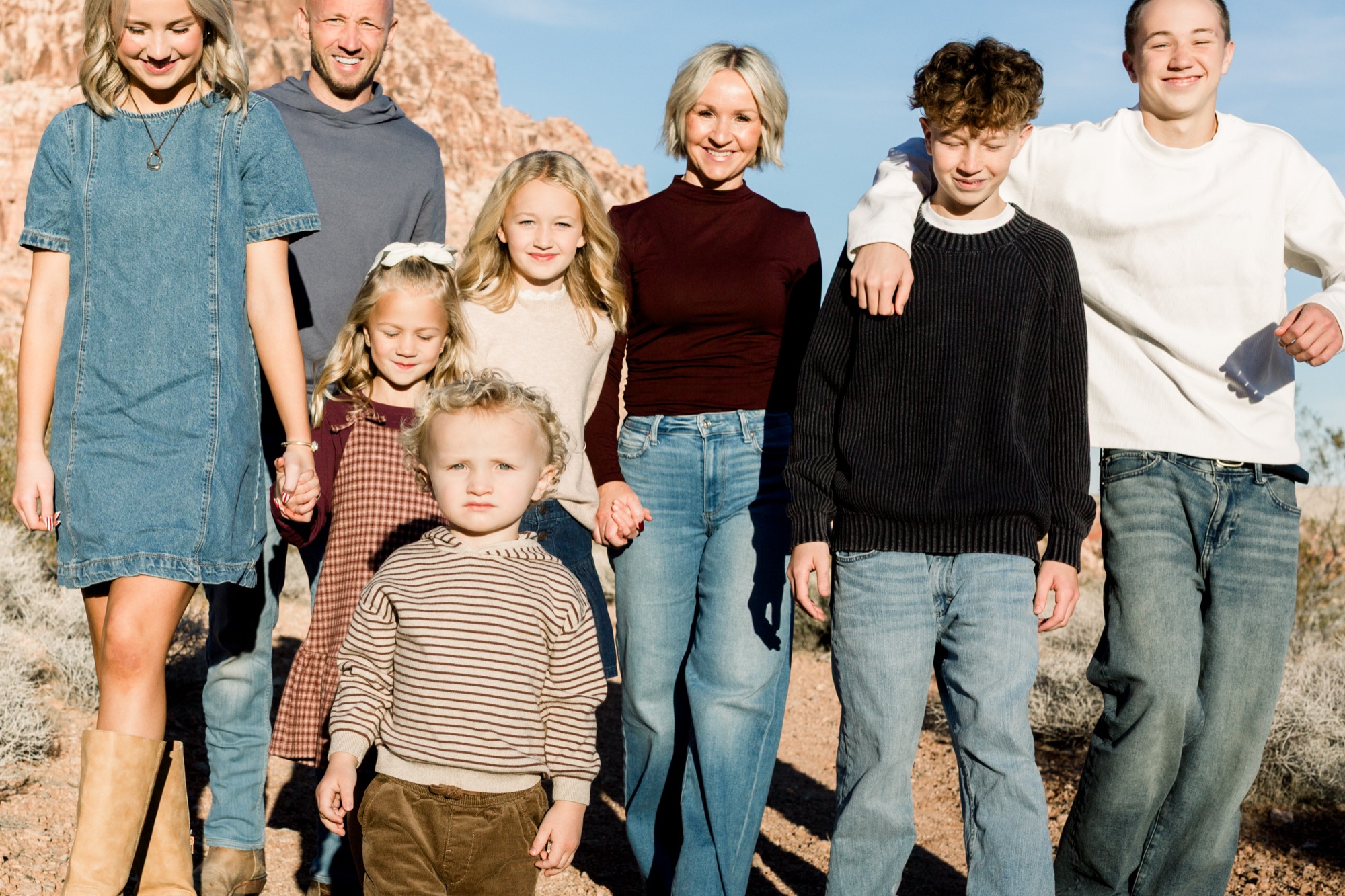 Large family in burgundy, cream, and denim at desert