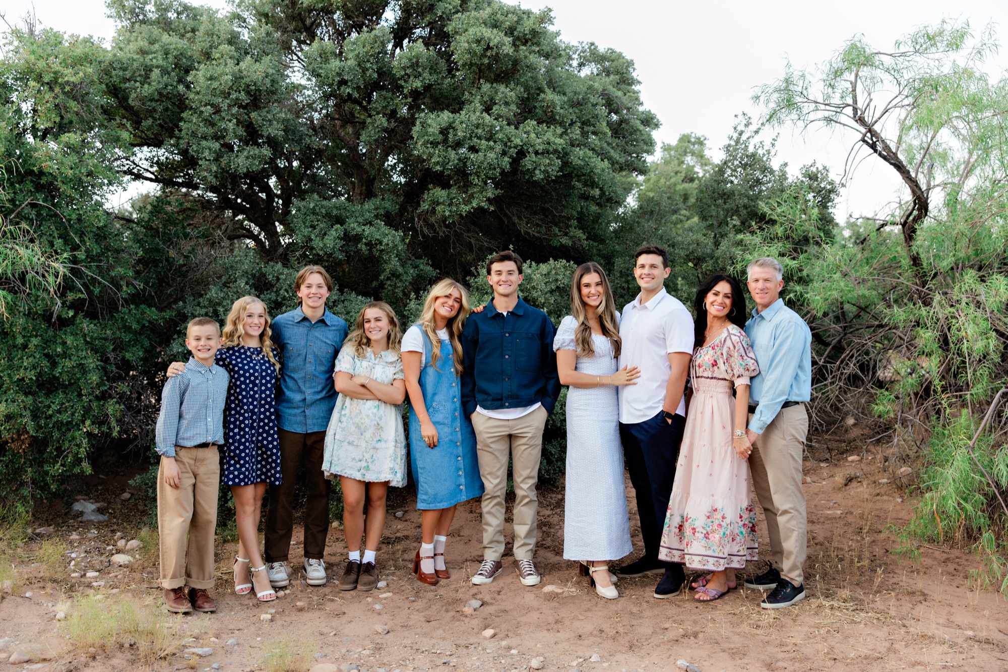 Large family group in blues and florals outdoors