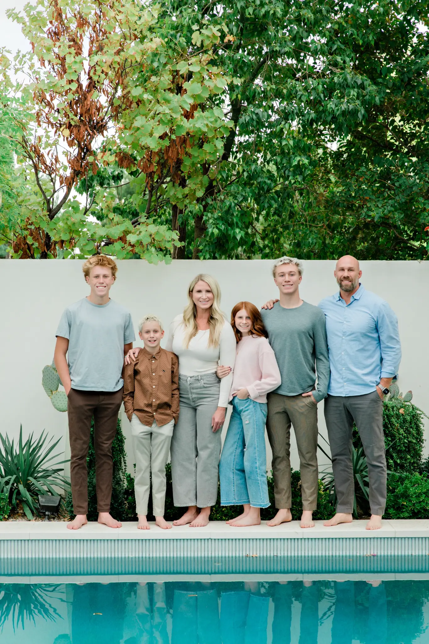 Family of six by the pool in blues and neutrals