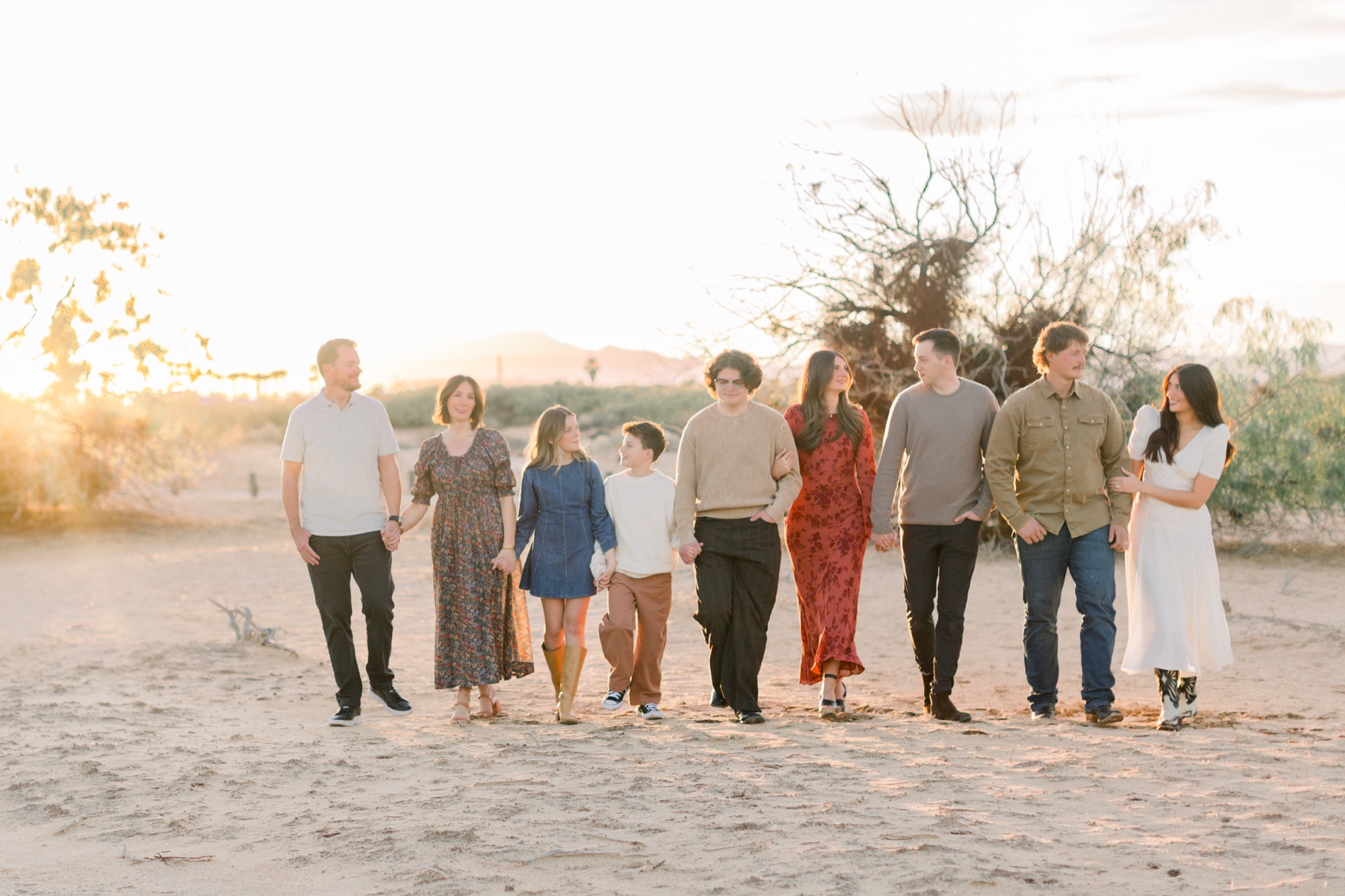 Family at golden hour on desert sand dunes