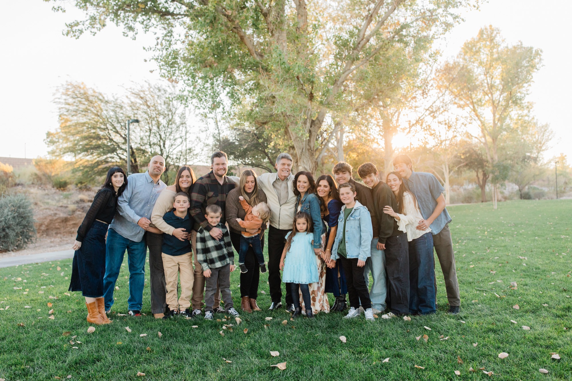 Large extended family in autumn tones at the park